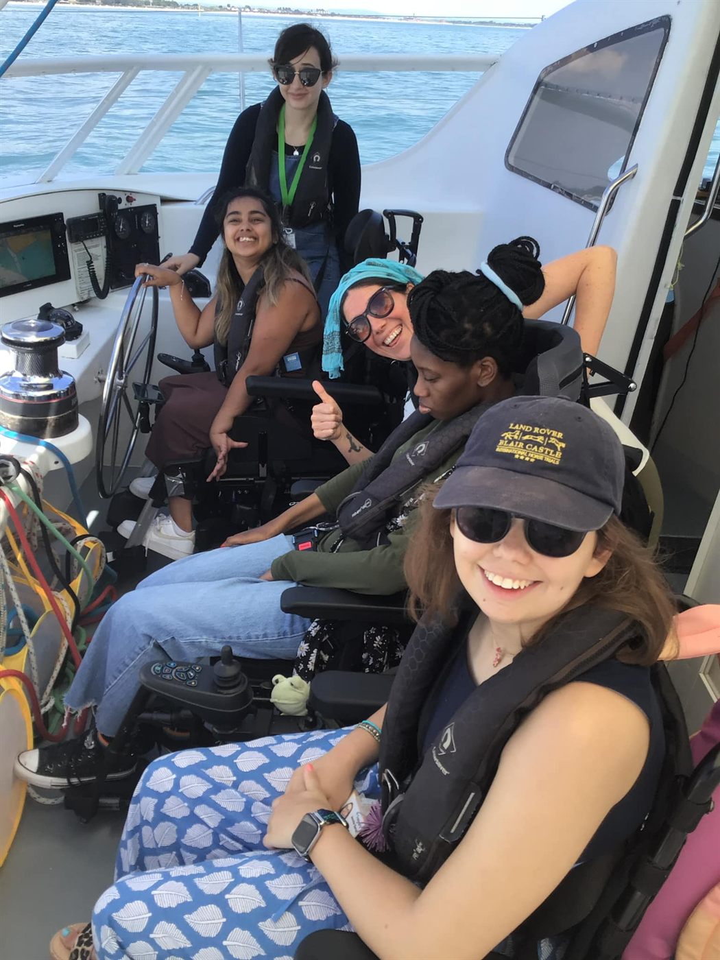 Wheelchair users enjoying a day sailing with the Disabled Sailors Association